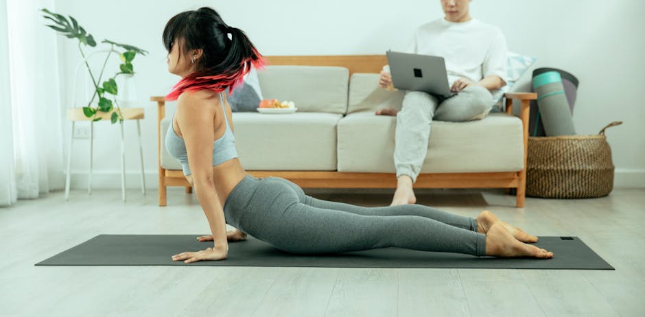 Woman gracefully doing a yoga pose on a purple mat at home